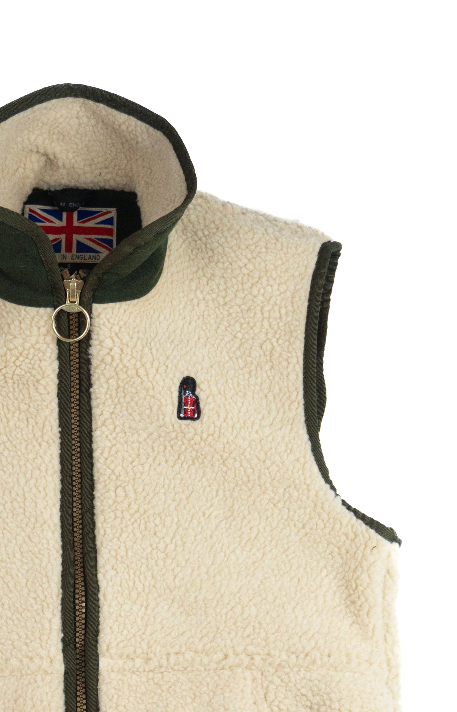 Beige fleece vest with a zipper and British flag patch on a white background