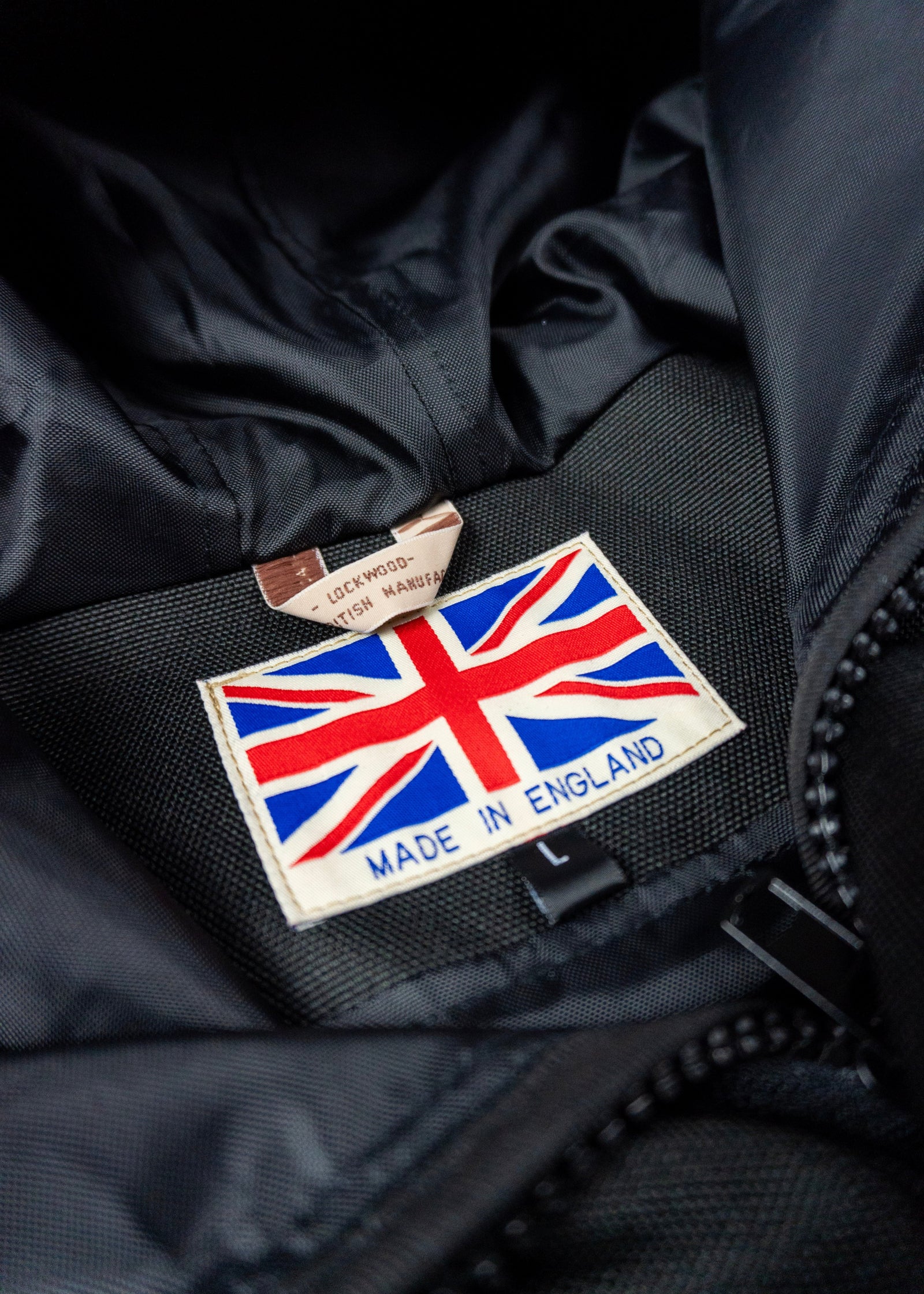 Black jacket with a Union Jack patch and 'Made in England' text