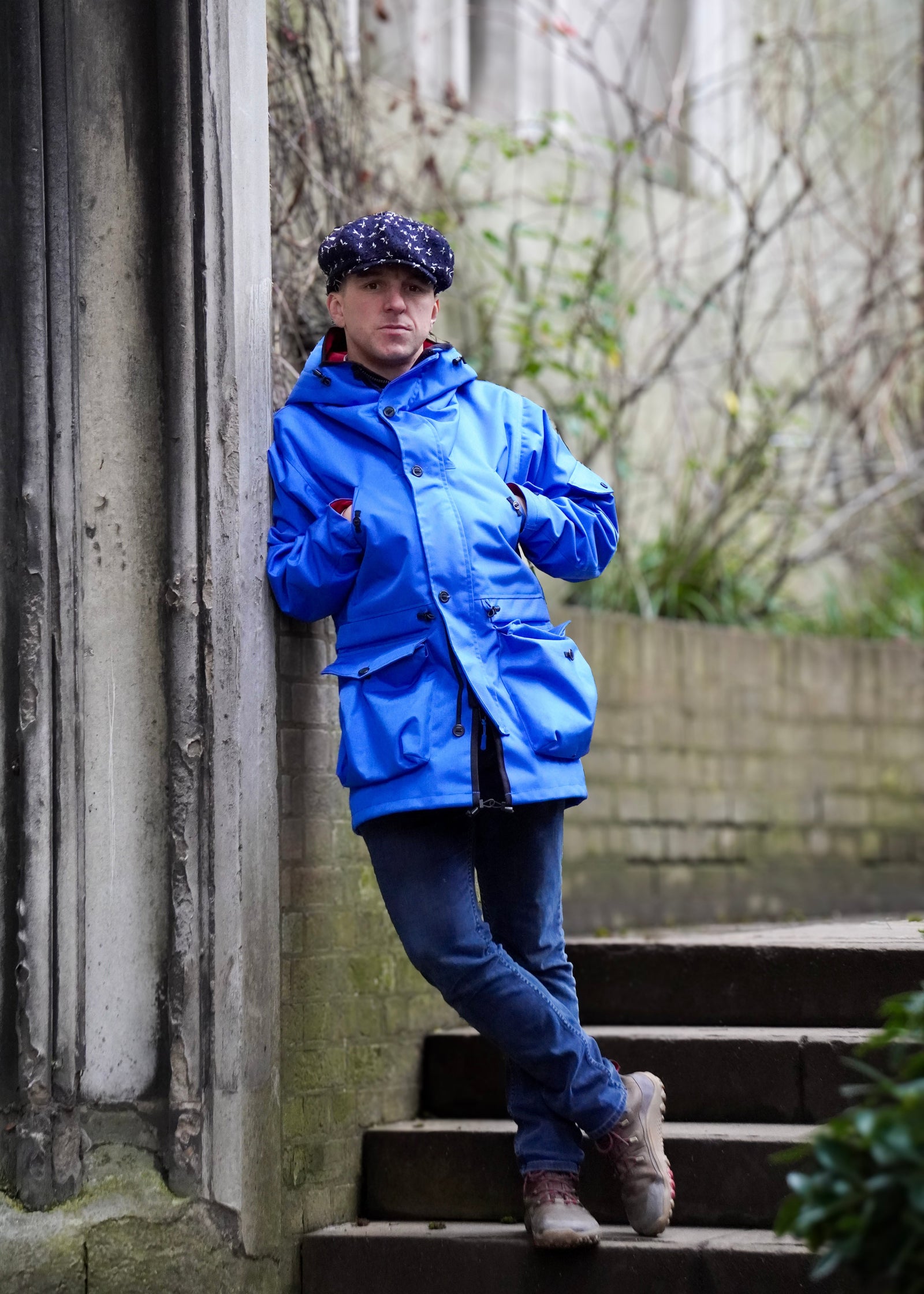person wearing a royal blue waterproof jacket