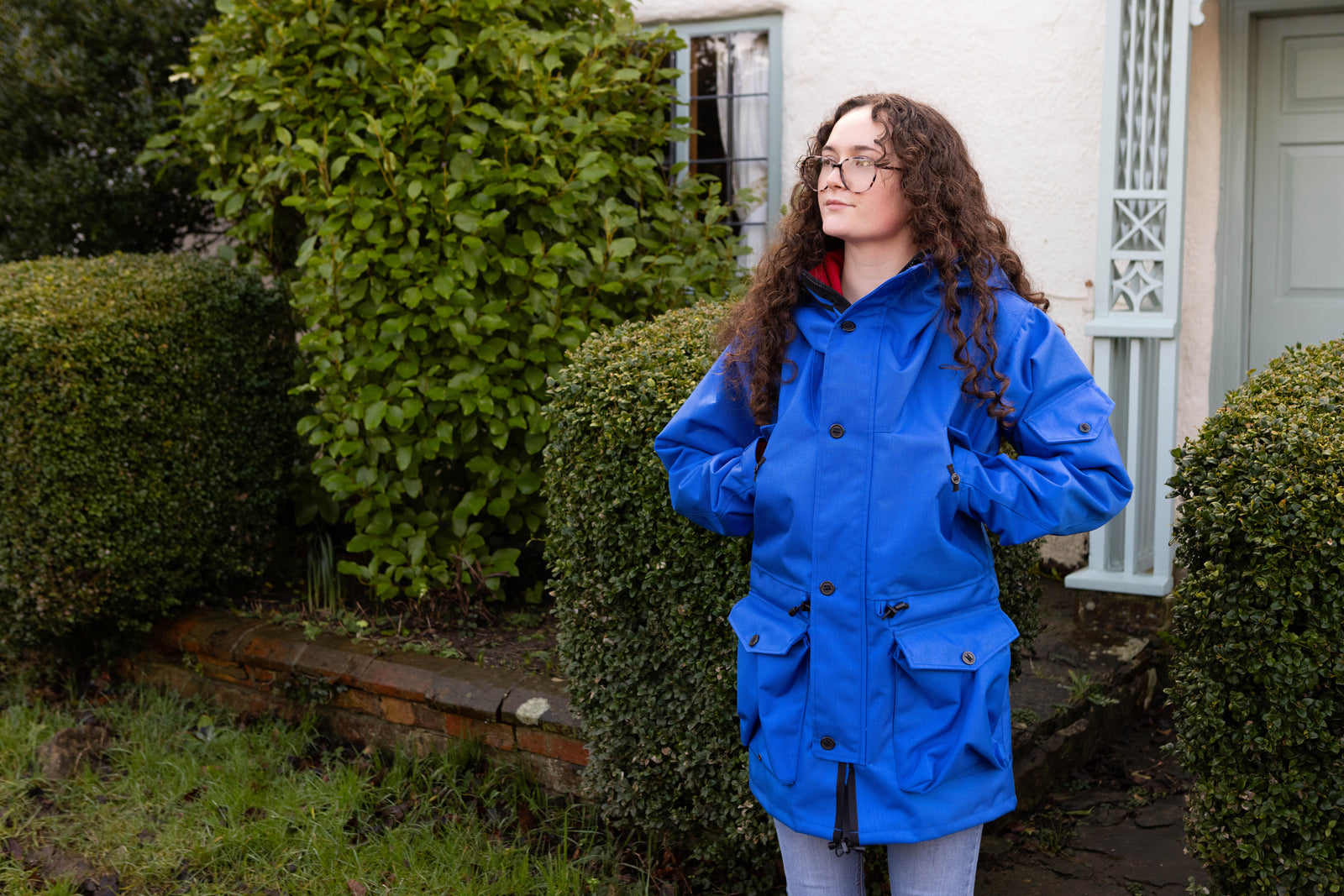 woman wearing a royal blue waterproof jacket