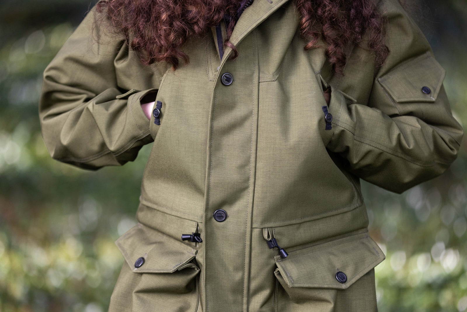 green water proof jacket with multiple pockets