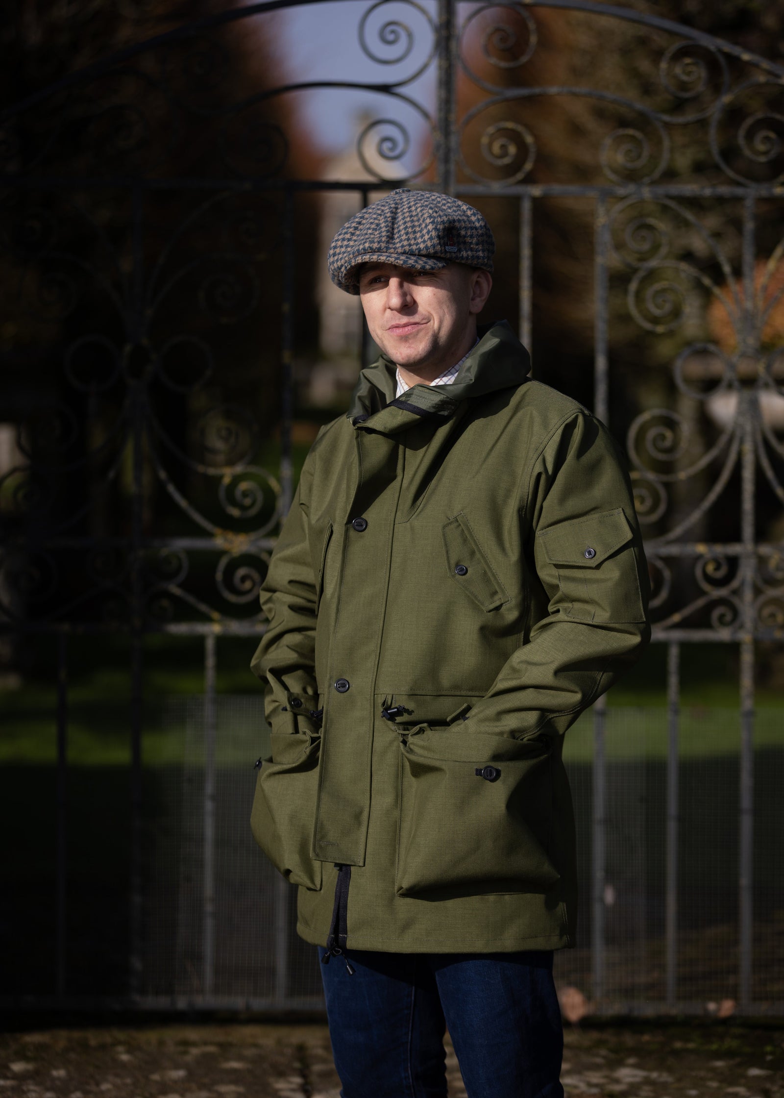 man in a country estate wearing a green waterproof jacket with multiple pockets