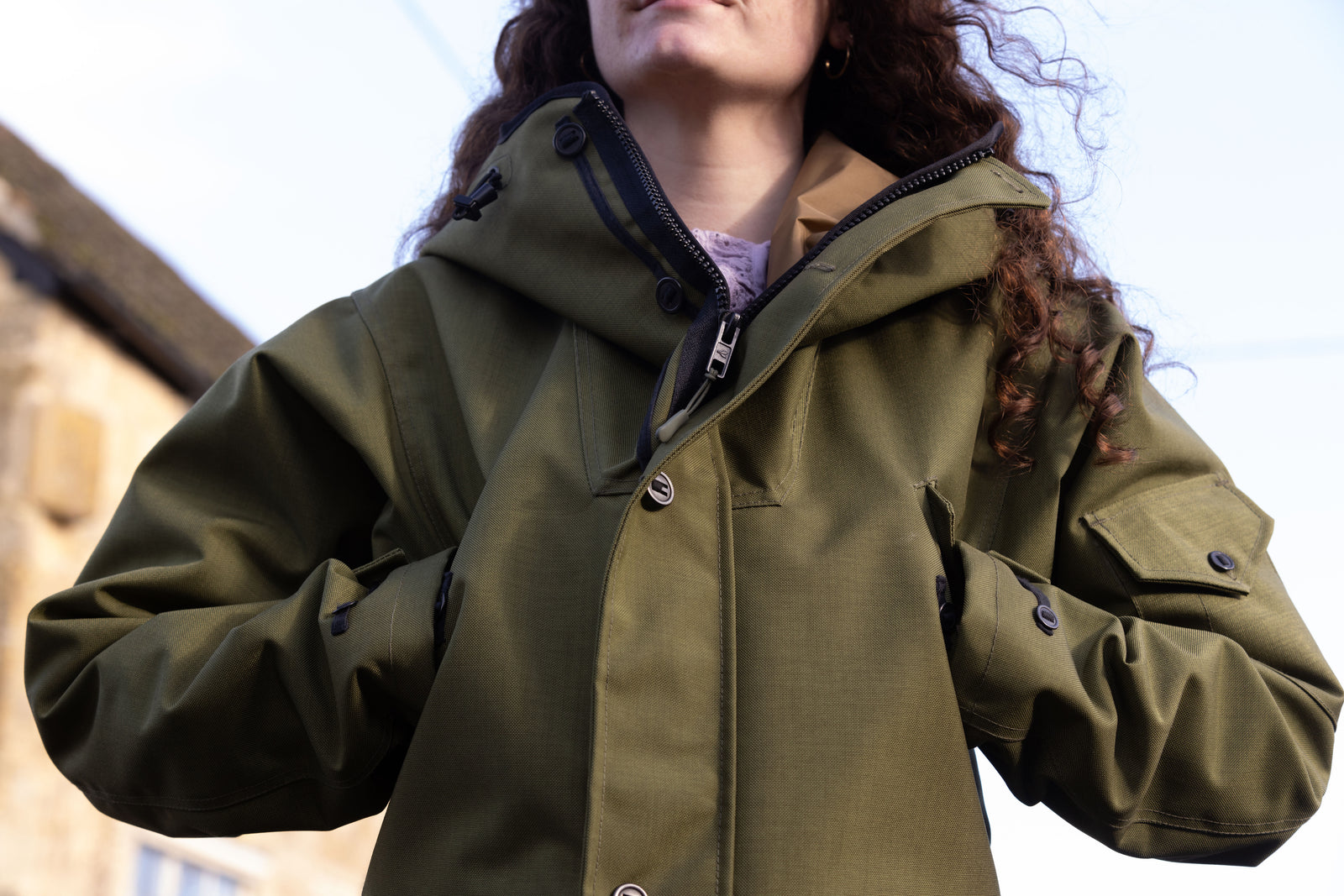 green waterproof jacket on a woman