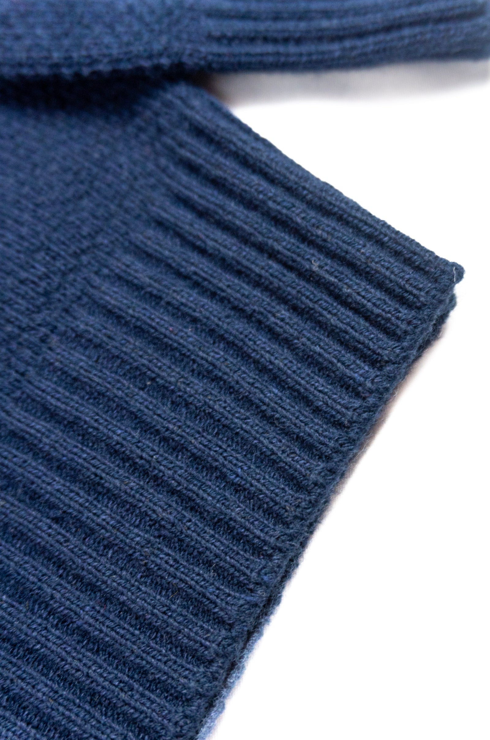 Close-up of a blue ribbed fabric texture on a white background