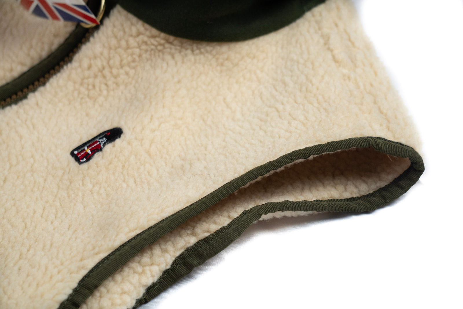 Close-up of a fleece-lined product with a small flag emblem on a white background