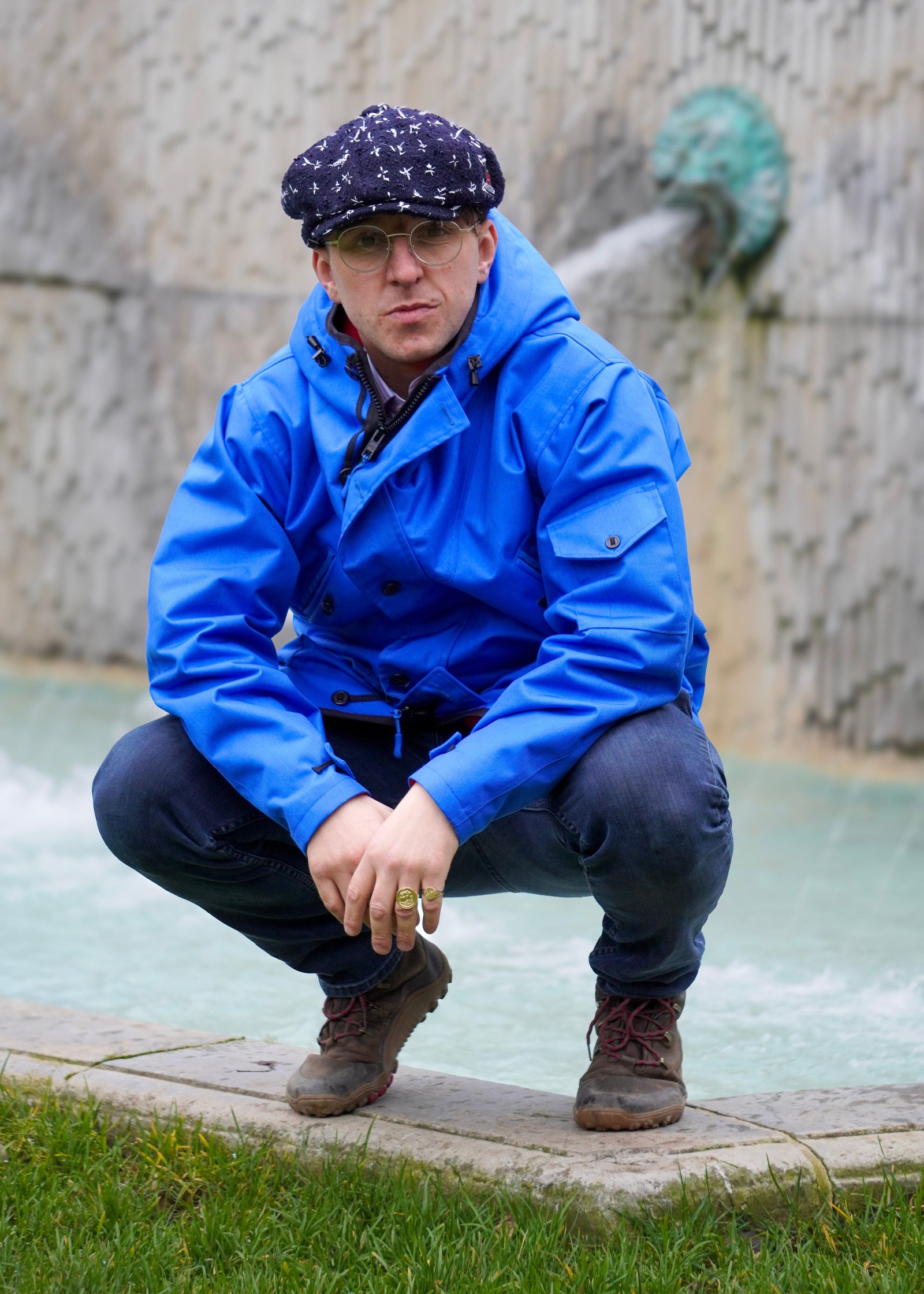 man wearing a royal blue waterproof jacket