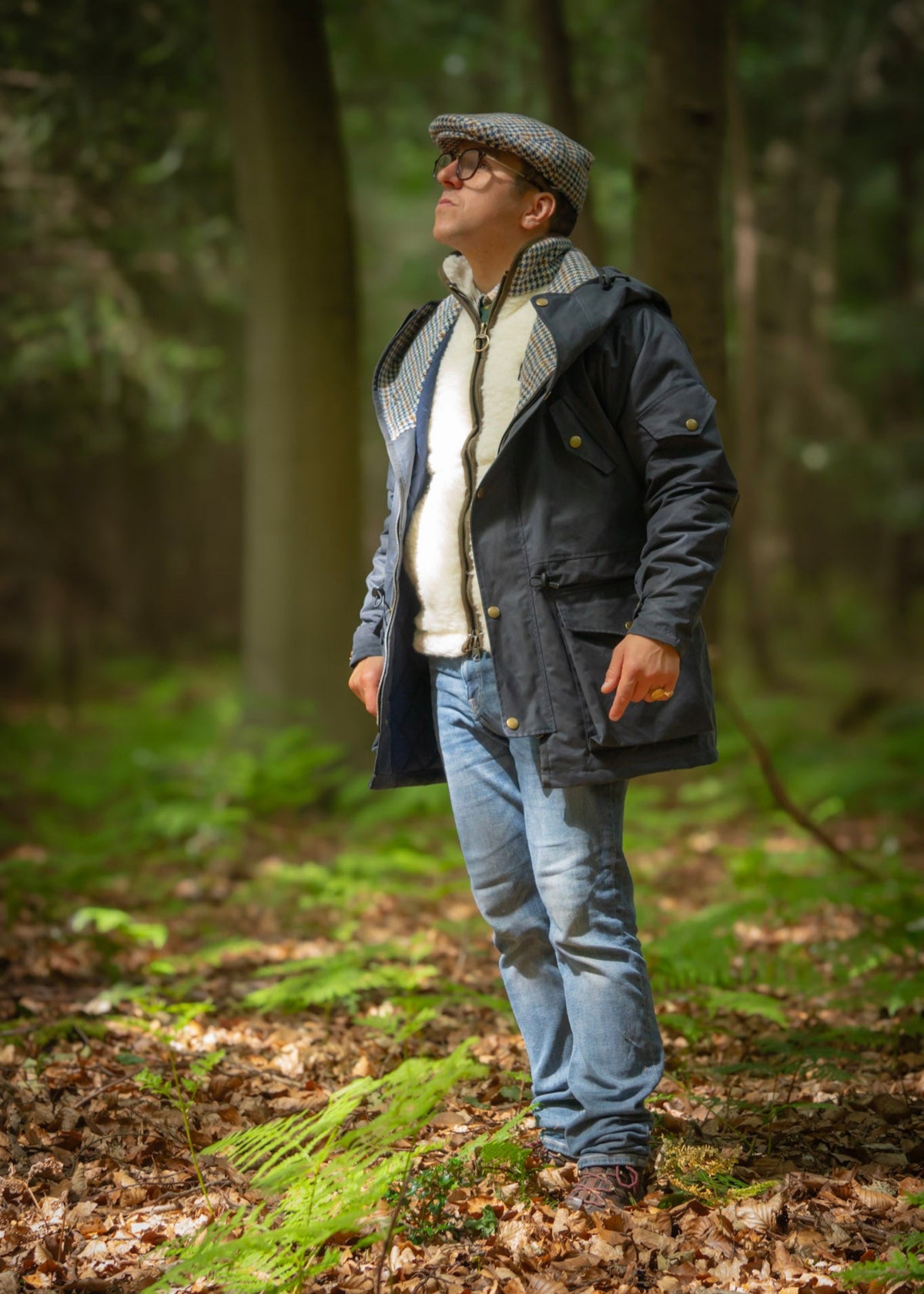 Man wearing waterproof Lockwood smocks jacket in a forest, showcasing British-made outdoor apparel.