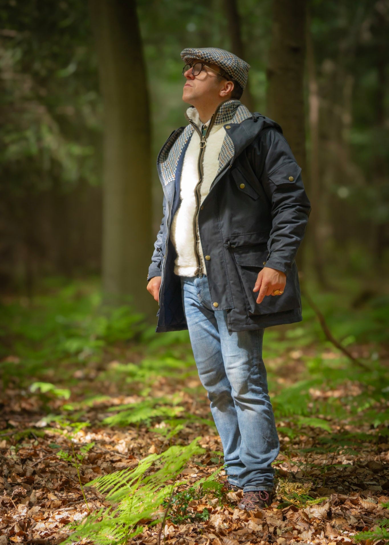 Man wearing waterproof Lockwood smocks jacket in a forest, showcasing British-made outdoor apparel.