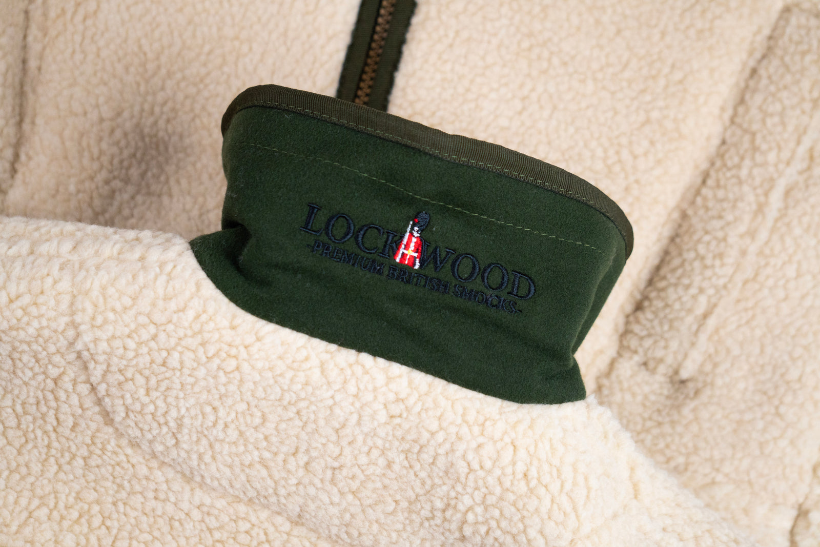 Close-up of a fleece jacket with a visible brand logo on the collar.