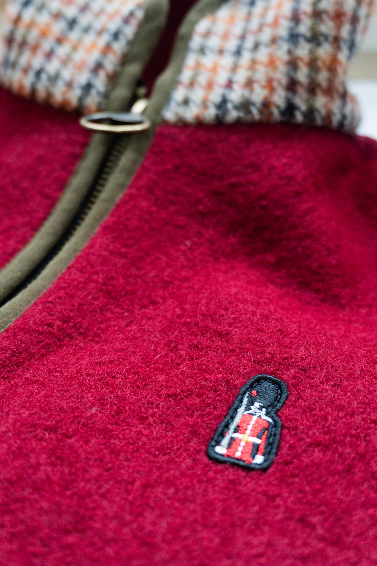 Close-up of a red fleece gilet with a small logo on the chest.