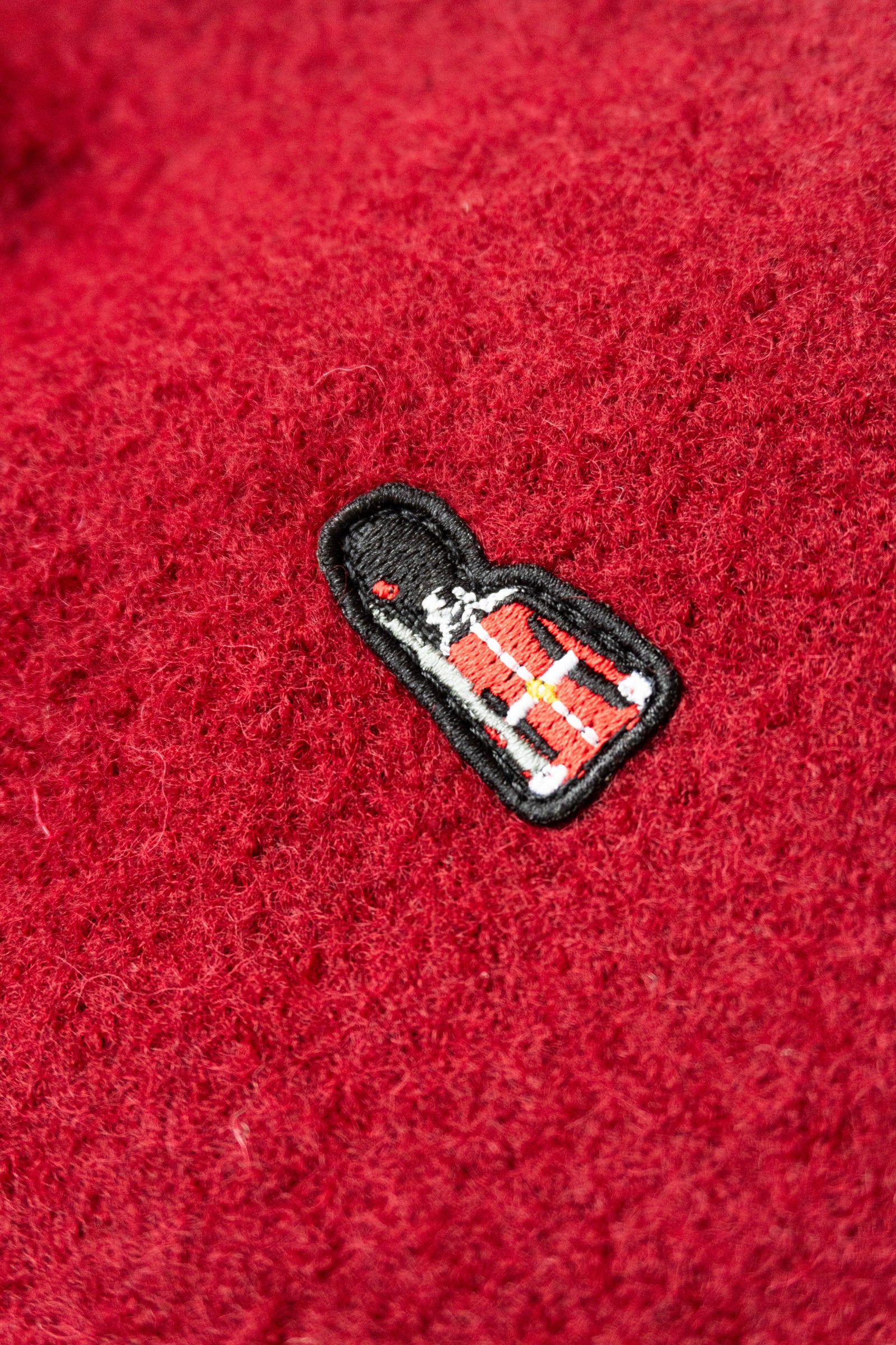 Embroidered patch on a red fabric background