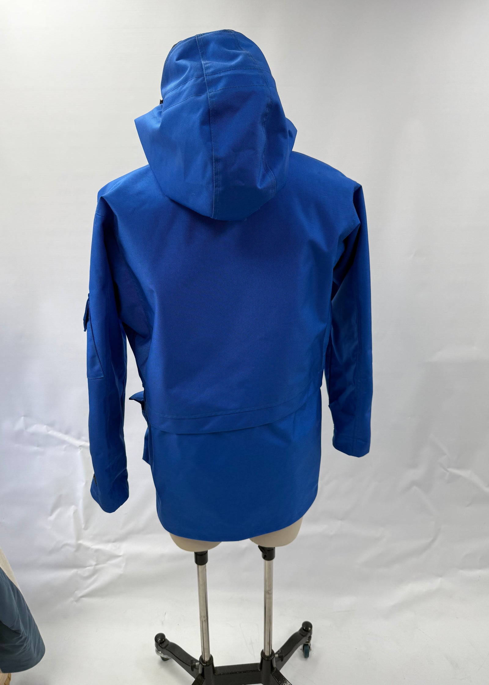 waterproof jacket in blue on a coat stand