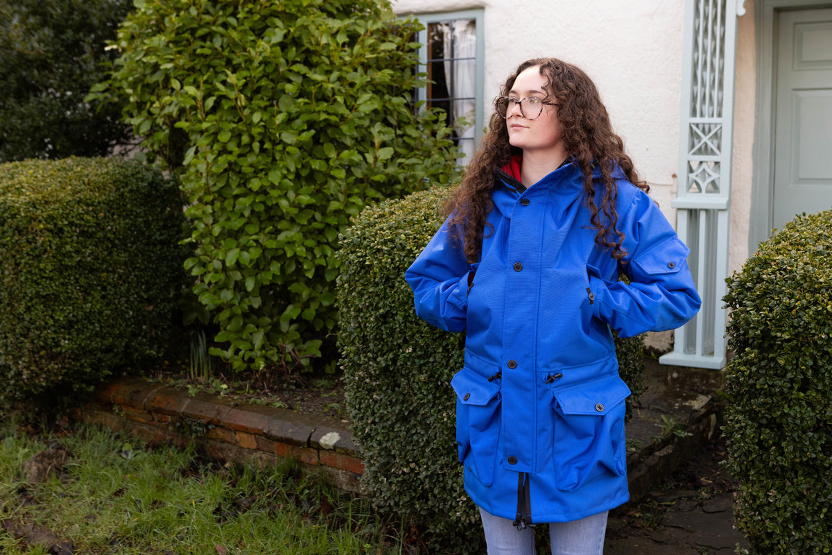 woman wearing a royal blue waterproof jacket