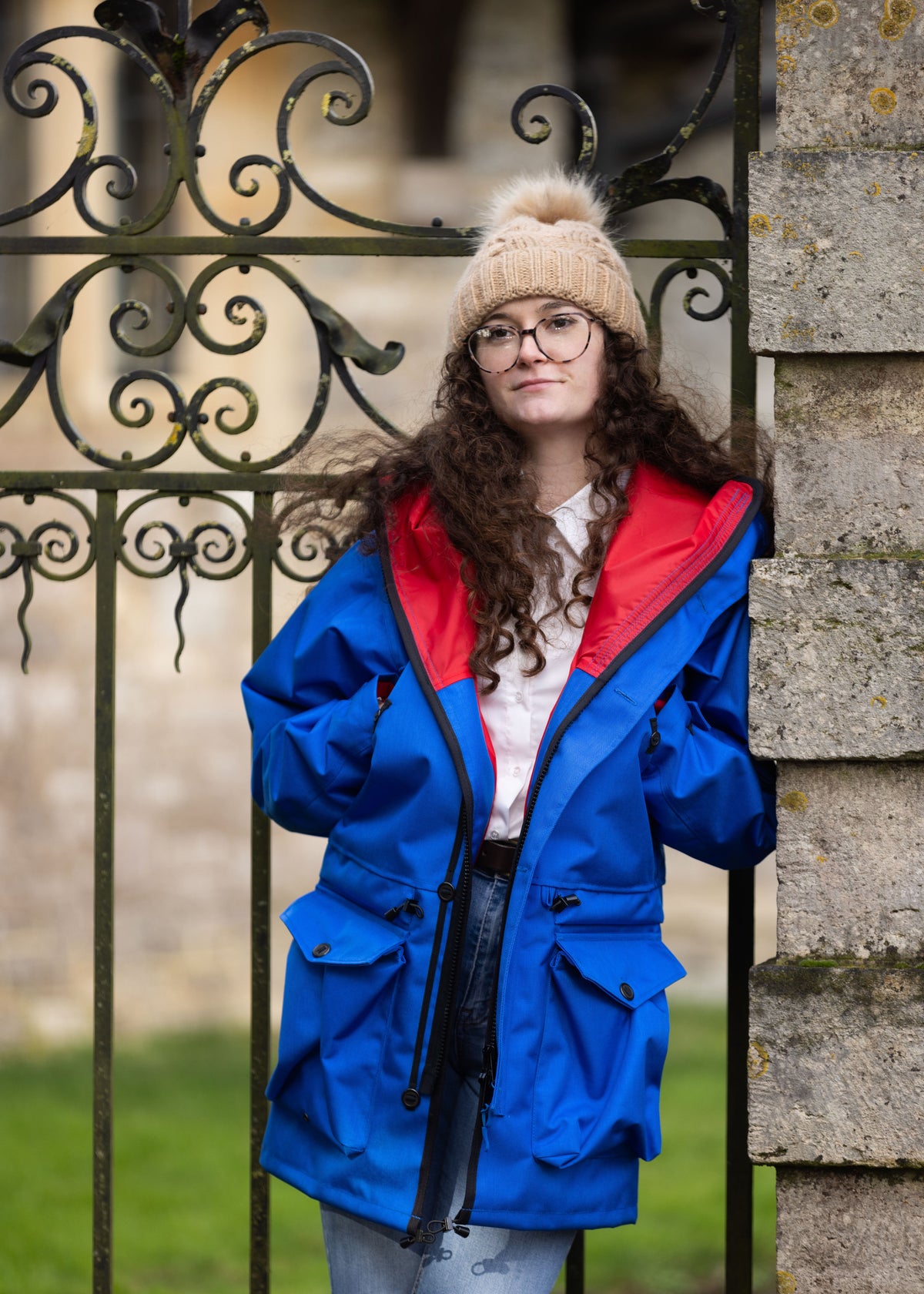 person wearing a blue smock with red lining 